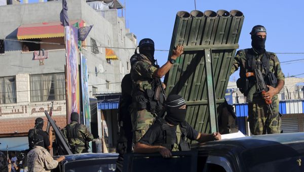 Palestinian militants from the al-Nasser Brigades, an armed wing of the Popular Resistance Committees (PRC), stand near rocket launcher while marching on their vehicles a long the streets during a rally to commemorate the 17th anniversary of their group in Rafah refugee camp, Gaza Strip, Monday, Sept. 26, 2016 - Sputnik International