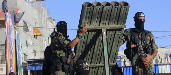 Palestinian militants from the al-Nasser Brigades, an armed wing of the Popular Resistance Committees (PRC), stand near rocket launcher while marching on their vehicles a long the streets during a rally to commemorate the 17th anniversary of their group in Rafah refugee camp, Gaza Strip, Monday, Sept. 26, 2016 Palestinian militants from the al-Nasser Brigades, an armed wing of the Popular Resistance Committees (PRC), stand near rocket launcher while marching on their vehicles a long the streets during a rally to commemorate the 17th anniversary of their group in Rafah refugee camp, Gaza Strip, Monday, Sept. 26, 2016 - Sputnik International