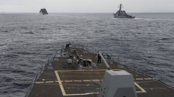 This image provided by the U.S. Navy, taken Oct. 17, 2016, shows the guided missile destroyer USS Decatur, right, pulling into position behind the Military Sealift Command USNS Matthew Perry, during a replenishment-at-sea, seen from the bridge of the guided-missile destroyer USS Spruance, in the South China Sea - Sputnik International