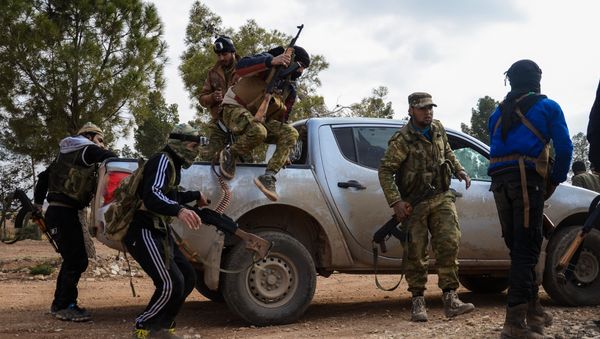 Fighters from the Free Syrian Army disembark from an armoured vehicle near the town of Bizaah northeast of the city of Al-Bab, some 30 kilometres from the Syrian city of Aleppo, on February 4, 2017 - Sputnik International
