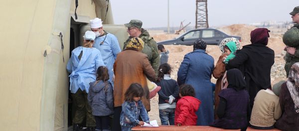 Syria. Treating people at the Jibrin temporary refugee accommodation center in Aleppo. This re-cropped photo courtesy of the Russian Center for Reconciliation of the Warring Parties in Syria - Sputnik International