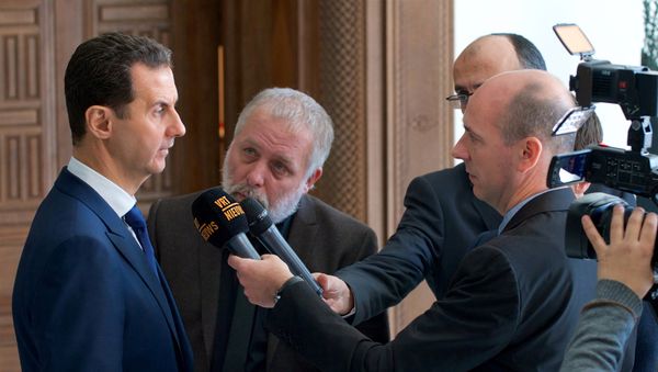 Syria's President Bashar al-Assad speaks to a group of Belgian reporters in this handout picture provided by SANA on February 7, 2017, Syria Syria's President Bashar al-Assad speaks to a group of Belgian reporters in this handout picture provided by SANA on February 7, 2017, Syria - Sputnik International