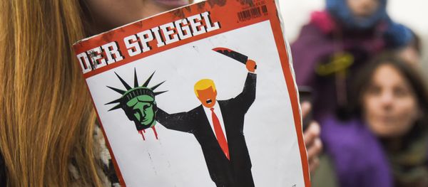 A young woman holds the last edition of Der Spiegel magazine with a cover designed by Edel Rodriguez, as she protests against the travel ban imposed by US President Donald Trump, on February 4, 2017, in Berlin - Sputnik International