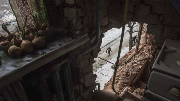 A local resident walking in a street is seen through a hole in an apartment building damaged by shelling in Avdiivka, Ukraine, Saturday, Feb. 4, 2017 A local resident walking in a street is seen through a hole in an apartment building damaged by shelling in Avdiivka, Ukraine, Saturday, Feb. 4, 2017 - Sputnik International