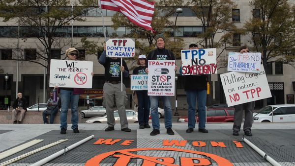 People hold signs as they demonstrate against the Trans-Pacific Partnership (TPP) trade agreement in Washington, DC, on November 14, 2016 People hold signs as they demonstrate against the Trans-Pacific Partnership (TPP) trade agreement in Washington, DC, on November 14, 2016 - Sputnik International