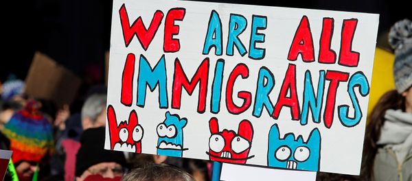 A demonstrator holds a sign to protest against U.S President Donald Trump's executive order banning refugees and immigrants from seven primarily Muslim countries from entering the United States during a rally in Philadelphia, Pennsylvania, U.S. February 4, 2017 - Sputnik International