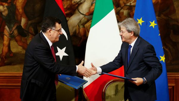 Italian Prime Minister Paolo Gentiloni (R) and his Libyan counterpart Fayez al-Sarraj shake hands after signing a bilateral agreement during a meeting at Chigi Palace in Rome, Italy February 2, 2017. Italian Prime Minister Paolo Gentiloni (R) and his Libyan counterpart Fayez al-Sarraj shake hands after signing a bilateral agreement during a meeting at Chigi Palace in Rome, Italy February 2, 2017. - Sputnik International