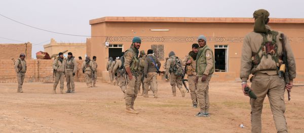 Syrian Democratic Forces (SDF) fighters walk with their weapons during an offensive against Daesh terrorists in northern Raqqa province, Syria Syrian Democratic Forces (SDF) fighters walk with their weapons during an offensive against Daesh terrorists in northern Raqqa province, Syria - Sputnik International