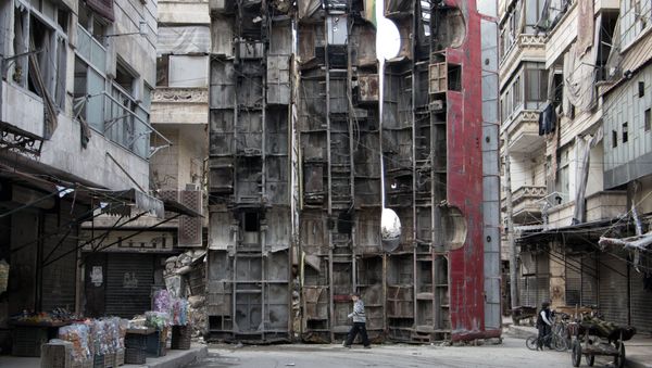 This file photo taken on March 14, 2015 shows a young boy walking past a makeshift barricade made of wreckages of buses to obstruct the view of regime snipers and to keep people safe in the rebel-held side of the northern Syrian city of Aleppo. This file photo taken on March 14, 2015 shows a young boy walking past a makeshift barricade made of wreckages of buses to obstruct the view of regime snipers and to keep people safe in the rebel-held side of the northern Syrian city of Aleppo. - Sputnik International