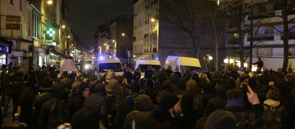 Police block a street as people gather to protest against an alleged police assault on a black man while in custody in central Paris Police block a street as people gather to protest against an alleged police assault on a black man while in custody in central Paris - Sputnik International