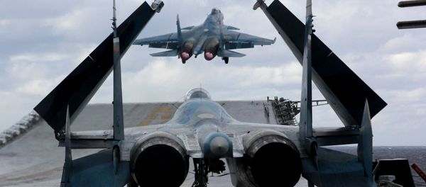 Su-33 and MiG-29K fighters aboard Admiral Kuznetsov heavy aircraft carrier in the Mediterranean Sea. Su-33 and MiG-29K fighters aboard Admiral Kuznetsov heavy aircraft carrier in the Mediterranean Sea. - Sputnik International