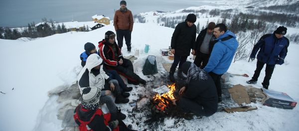 Asylum seekers gather round a fire as they cook a meal overlooking the temporary Altnes camp refugee camp on the island of Seiland, northern Norway Asylum seekers gather round a fire as they cook a meal overlooking the temporary Altnes camp refugee camp on the island of Seiland, northern Norway - Sputnik International
