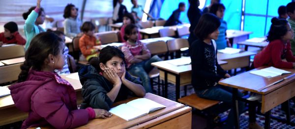 Syrian  children take lessons on November 10, 2014 in a makeshift school tent in a refugee camp in the town of Suruc, Sanliurfa province (File) - Sputnik International