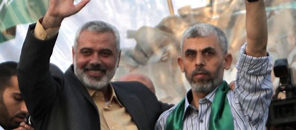 This file photo taken on October 21, 2011 shows then Hamas leader Ismail Haniya (L) and freed Palestinian prisoner Yahya Sinwar (R), a founder of Hamas' military wing, waving as supporters celebrate the release of hundreds of prisoners following a swap with captured Israeli soldier Gilad Shalit in Khan Yunis, southern Gaza Strip This file photo taken on October 21, 2011 shows then Hamas leader Ismail Haniya (L) and freed Palestinian prisoner Yahya Sinwar (R), a founder of Hamas' military wing, waving as supporters celebrate the release of hundreds of prisoners following a swap with captured Israeli soldier Gilad Shalit in Khan Yunis, southern Gaza Strip - Sputnik International