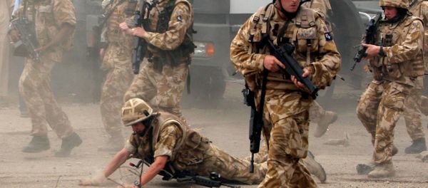 In this May 6 , 2006 file photo, a British trooper falls after apparently being hit by a rock, as British troops move towards a helicopter crash site in Basra, Iraq's second-largest city, 550 kilometers (340 miles) southeast of Baghdad. Britain’s prime minister announced plans on Oct. 4, 2016 to protect British troops from dubious legal claims made during conflicts. In this May 6 , 2006 file photo, a British trooper falls after apparently being hit by a rock, as British troops move towards a helicopter crash site in Basra, Iraq's second-largest city, 550 kilometers (340 miles) southeast of Baghdad. Britain’s prime minister announced plans on Oct. 4, 2016 to protect British troops from dubious legal claims made during conflicts. - Sputnik International