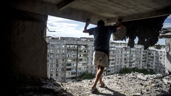 Man inspects damaged residential building in the Mirny district of Lugansk, hit by artillery fire. File photo Man inspects damaged residential building in the Mirny district of Lugansk, hit by artillery fire. File photo - Sputnik International