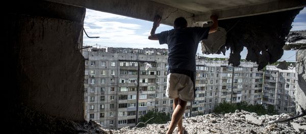 Man inspects damaged residential building in the Mirny district of Lugansk, hit by artillery fire. File photo Man inspects damaged residential building in the Mirny district of Lugansk, hit by artillery fire. File photo - Sputnik International