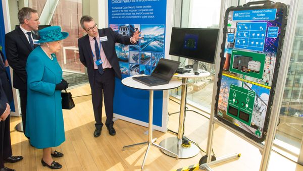 Britain's Queen Elizabeth II (2L) listens as Director of Engagement and Advice Alex Dewdney (R) explains how an electricity supply could be subjected to cyber attack, as she attends the opening of the National Cyber Security Centre in London on February 14, 2017. - Sputnik International