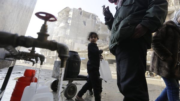 This file photo taken on January 21, 2017 shows Syrians standing next to water faucets as they fill jerrycans in Aleppo's formerly rebel-held al-Shaar neighbourhood, a month after government forces retook the northern Syrian city from rebel fighters This file photo taken on January 21, 2017 shows Syrians standing next to water faucets as they fill jerrycans in Aleppo's formerly rebel-held al-Shaar neighbourhood, a month after government forces retook the northern Syrian city from rebel fighters - Sputnik International