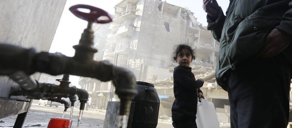 This file photo taken on January 21, 2017 shows Syrians standing next to water faucets as they fill jerrycans in Aleppo's formerly rebel-held al-Shaar neighbourhood, a month after government forces retook the northern Syrian city from rebel fighters - Sputnik International