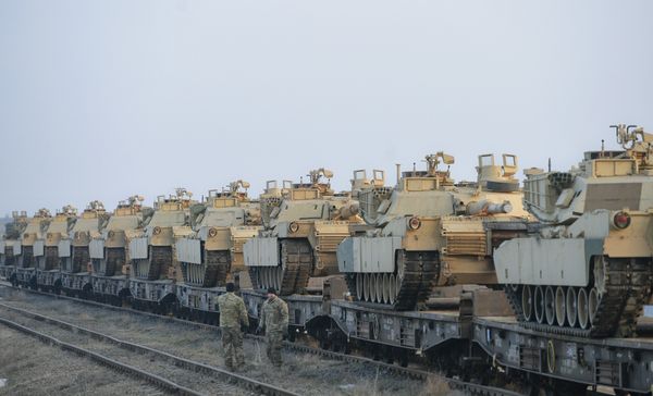 Servicemen of the Fighting Eagles 1st Battalion, 8th Infantry Regiment, walk by tanks that arrived via train to the US base in Mihail Kogalniceanu, eastern Romania, Tuesday, Feb. 14, 2017. Servicemen of the Fighting Eagles 1st Battalion, 8th Infantry Regiment, walk by tanks that arrived via train to the US base in Mihail Kogalniceanu, eastern Romania, Tuesday, Feb. 14, 2017. - Sputnik International