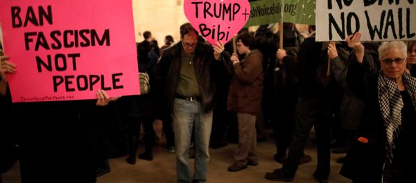 Demonstrators hold signs during a Muslim and Jewish Solidarity protest against the policies of U.S. President Donald Trump and Israeli Prime Minister Benjamin Netanyahu at Grand Central Terminal in New York City, U.S. Demonstrators hold signs during a Muslim and Jewish Solidarity protest against the policies of U.S. President Donald Trump and Israeli Prime Minister Benjamin Netanyahu at Grand Central Terminal in New York City, U.S. - Sputnik International