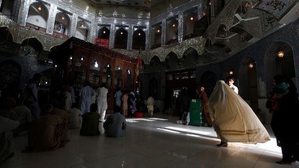A woman clad in burqa walks in the hallway of the tomb of Sufi saint Syed Usman Marwandi, also known as Lal Shahbaz Qalandar, in Sehwan Sharif, in Pakistan's southern Sindh province. (File) A woman clad in burqa walks in the hallway of the tomb of Sufi saint Syed Usman Marwandi, also known as Lal Shahbaz Qalandar, in Sehwan Sharif, in Pakistan's southern Sindh province. (File) - Sputnik International
