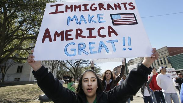 A protester holds a sign during a Day Without Immigrants Protest in Texas A protester holds a sign during a Day Without Immigrants Protest in Texas - Sputnik International
