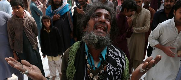 A man mourns the death of a relative who was killed in a suicide blast at the tomb of Sufi saint Syed Usman Marwandi, also known as the Lal Shahbaz Qalandar shrine, on Thursday evening in Sehwan Sharif, Pakistan's southern Sindh province, February 17, 2017. A man mourns the death of a relative who was killed in a suicide blast at the tomb of Sufi saint Syed Usman Marwandi, also known as the Lal Shahbaz Qalandar shrine, on Thursday evening in Sehwan Sharif, Pakistan's southern Sindh province, February 17, 2017. - Sputnik International