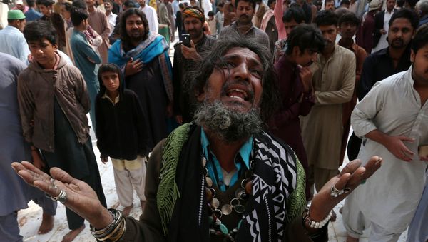 A man mourns the death of a relative who was killed in a suicide blast at the tomb of Sufi saint Syed Usman Marwandi, also known as the Lal Shahbaz Qalandar shrine, on Thursday evening in Sehwan Sharif, Pakistan's southern Sindh province, February 17, 2017. A man mourns the death of a relative who was killed in a suicide blast at the tomb of Sufi saint Syed Usman Marwandi, also known as the Lal Shahbaz Qalandar shrine, on Thursday evening in Sehwan Sharif, Pakistan's southern Sindh province, February 17, 2017. - Sputnik International
