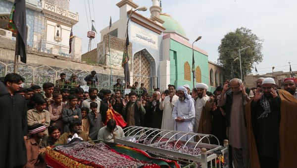 Men and relatives gather to attend funeral prayers for victims killed in a suicide blast at the tomb of Sufi saint Syed Usman Marwandi, also known as the Lal Shahbaz Qalandar shrine, during a funeral in Sehwan Sharif, Pakistan's southern Sindh province Men and relatives gather to attend funeral prayers for victims killed in a suicide blast at the tomb of Sufi saint Syed Usman Marwandi, also known as the Lal Shahbaz Qalandar shrine, during a funeral in Sehwan Sharif, Pakistan's southern Sindh province - Sputnik International