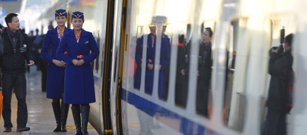 Train conductors stand outside the cabin of a bullet train Train conductors stand outside the cabin of a bullet train - Sputnik International