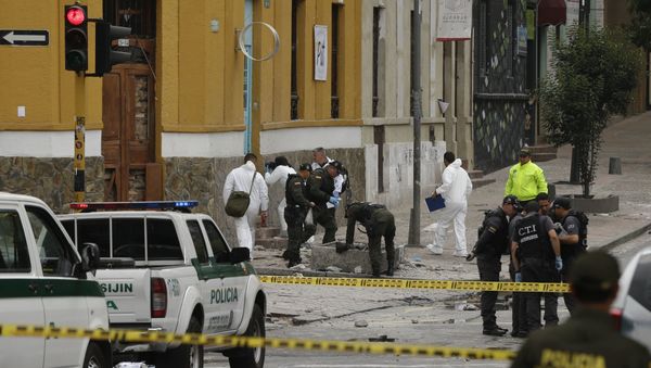 Police and investigators inspect the site where a homemade bomb exploded near the Santamaria bull ring in Bogota, Colombia - Sputnik International