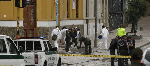Police and investigators inspect the site where a homemade bomb exploded near the Santamaria bull ring in Bogota, Colombia - Sputnik International