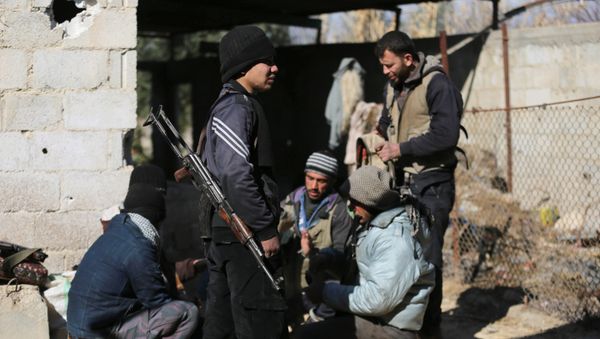 Fighters from the Jaish al-Islam (Islam Army), the foremost rebel group in Damascus province who fiercely oppose both the Syrian regime and the Islamic State group, gather inside a building on the frontline in the town of Bilaliyah, east of the capital Damascus, on February 4, 2017 Fighters from the Jaish al-Islam (Islam Army), the foremost rebel group in Damascus province who fiercely oppose both the Syrian regime and the Islamic State group, gather inside a building on the frontline in the town of Bilaliyah, east of the capital Damascus, on February 4, 2017 - Sputnik International