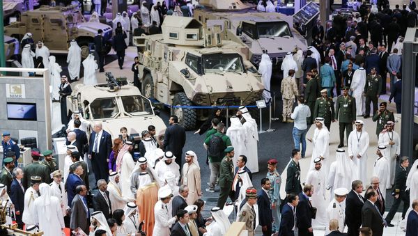 A picture taken on February 19, 2017 shows a general view of visitors walking in a showroom displaying armoured military vehicles during the opening of the International Defence Exhibition and Conference (IDEX) in the Emirati capital Abu Dhabi - Sputnik International
