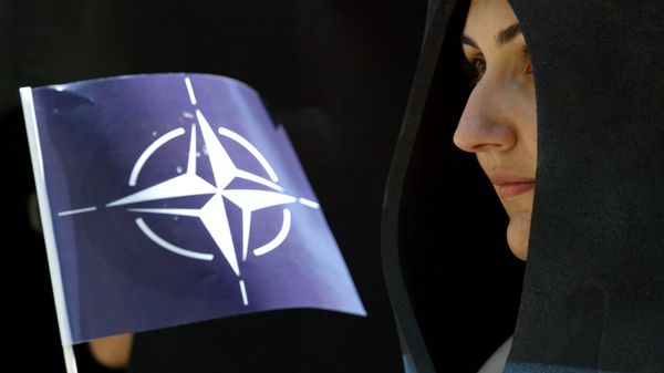 A activist holds a NATO flag during a demonstration in Istanbul, Turkey, Saturday, June 26, 2004. - Sputnik International
