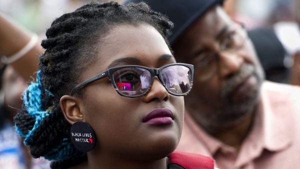 A young woman wears earrings with the slogan Black Lives Matter printed on them during the dedication and opening ceremony of the Smithsonian's National Museum of African American History and Culture in Washington, Saturday, Sept. 24, 2016.  - Sputnik International