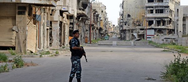 A police officer patrols a street in Homs. (File) - Sputnik International