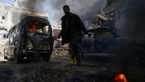 A civil defence member works amid burning vehicles at a site hit by airstrikes in the rebel held besieged Douma neighbourhood of Damascus, Syria, February 26, 2017. A civil defence member works amid burning vehicles at a site hit by airstrikes in the rebel held besieged Douma neighbourhood of Damascus, Syria, February 26, 2017. - Sputnik International