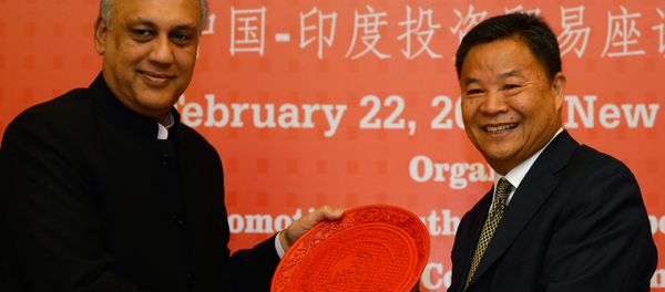 Vice chairman of the CPPCC Foreign Affairs Committee Lu Xinhua (R) is presented a memento by former Federation of Indian Chambers of Commerce and Industry (FICCI) president and current chairman of XPRO India Sidharth Birla at a China-India business meeting for investment and trade at Federation of Indian Chambers of Commerce and Industry in New Delhi on February 22, 2017. Vice chairman of the CPPCC Foreign Affairs Committee Lu Xinhua (R) is presented a memento by former Federation of Indian Chambers of Commerce and Industry (FICCI) president and current chairman of XPRO India Sidharth Birla at a China-India business meeting for investment and trade at Federation of Indian Chambers of Commerce and Industry in New Delhi on February 22, 2017. - Sputnik International