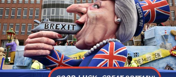 A carnival float depicts British Prime Minister Theresa May with a gun and the writing 'Brexit' on it prior to the traditional carnival parade in Duesseldorf, Germany, on Monday, Feb. 27, 2017. - Sputnik International