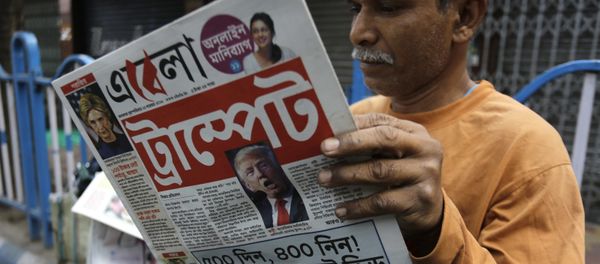 An Indian man reads a Bengali language newspaper that has the words 'Trumped headlined to refer to U.S President-elect Donald Trump's election victory in Kolkata, India, Thursday, Nov. 10, 2016 - Sputnik International