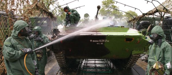 Indian Army soldiers wear protective suits and wash a tank as they perform a chemical weapon decontamination exercise, during a military exercise in Jagraon, in the northern Indian state of Punjab (File) Indian Army soldiers wear protective suits and wash a tank as they perform a chemical weapon decontamination exercise, during a military exercise in Jagraon, in the northern Indian state of Punjab (File) - Sputnik International