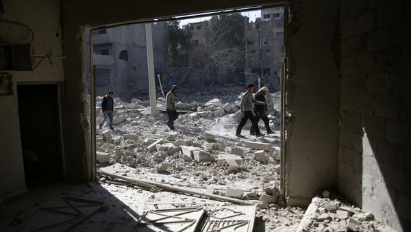 People walk at an area hit by airstrikes in the rebel held besieged Douma neighbourhood of Damascus, Syria. (File) - Sputnik International