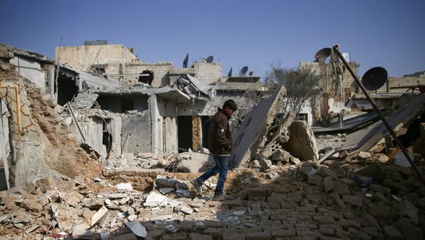 A boy walks on the rubble of damaged buildings in the rebel held besieged Douma neighbourhood of Damascus, Syria March 8, 2017 - Sputnik International