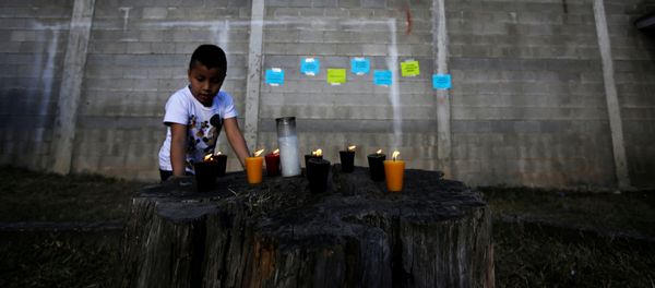 Candles are lit for victims after a fire broke out at the Virgen de Asuncion home in San Jose Pinula on the outskirts of Guatemala City, March 8, 2017 Candles are lit for victims after a fire broke out at the Virgen de Asuncion home in San Jose Pinula on the outskirts of Guatemala City, March 8, 2017 - Sputnik International
