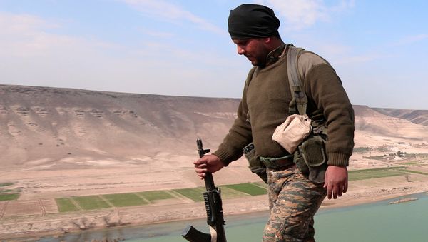 A Syrian Democratic Forces(SDF) fighter poses for a picture near Euphrates River, north of Raqqa city, Syria March 8, 2017 A Syrian Democratic Forces(SDF) fighter poses for a picture near Euphrates River, north of Raqqa city, Syria March 8, 2017 - Sputnik International