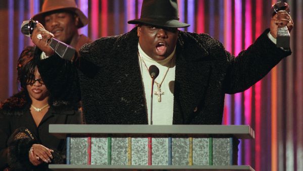In this December 6, 1995 file photo, Notorious B.I.G., who won rap artist and rap single of the year, clutches his awards at the podium during the annual Billboard Music Awards in New York. - Sputnik International