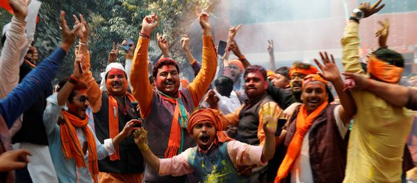 Supporters of India’s Bharatiya Janata Party (BJP) celebrate after learning of the initial poll results at the party headquarters in Lucknow, India March 11, 2017 - Sputnik International